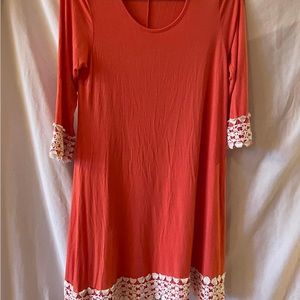 Cute coral Dress with pretty white lace at hem and edges of long sleeves. Lt wt